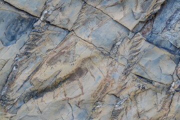 Mountain stone. Macro photo. Rough texture of mountain wild stone. Rough surface of an ancient mountain. Grunge texture. Laminated surface. Abstract grunge background. Marble. Granite. 