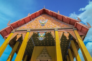 Fototapeta na wymiar Ant's eye view of ancient traditional gable roof, Nan style art, Wat Phra That Chang Kham Voravihara, Nan Province, northern of Thailand.