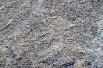 Mountain stone. Macro photo. Rough texture of mountain wild stone. Rough surface of an ancient mountain. Grunge texture. Laminated surface. Abstract grunge background. Marble. Granite. 