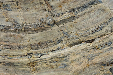 Mountain stone. Macro photo. Rough texture of mountain wild stone. Rough surface of an ancient mountain. Grunge texture. Laminated surface. Abstract grunge background. Marble. Granite. 