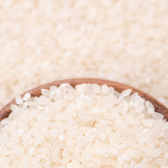 Raw rice in a bowl and full frame in the white background table, top view overhead shot, close up
