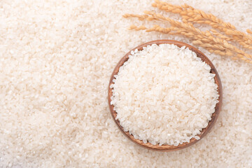 Fototapeta na wymiar Raw rice in a bowl and full frame in the white background table, top view overhead shot, close up