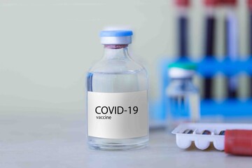 Bottle of coronavirus vaccine on the table. Development and creation of a coronavirus vaccine COVID-19. 