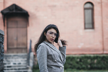 Fototapeta premium Hipster girl in glasses in city street