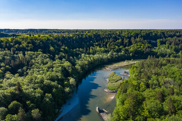 High aerial view of Isar river in Spring with forest and amazing ecological landscape around. Drone...