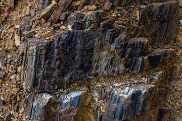 the background and rough dark stone texture closeup