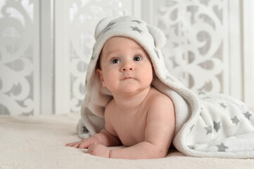 Portrait of cute little baby boy on bed