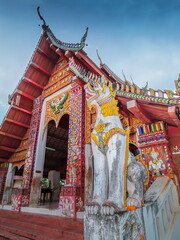 Fototapeta premium view of Singha guardian sculpture in front of buddhist temple, the mythical creatures animal, Wat Wiang Sa, Nan Province, northern of Thailand.