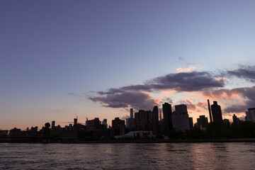 Fototapeta na wymiar Manhattan and Roosevelt Island Skyline Silhouette during Sunset in New York City along the East River