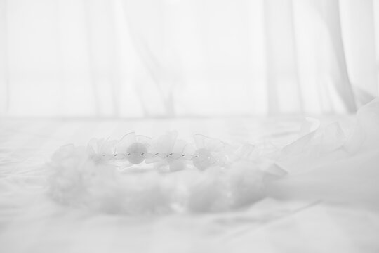 wedding white bridal veil on bed. tulle gathered in hair hoop