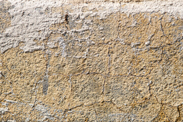 background and texture of old concrete wall with cracked paint on it