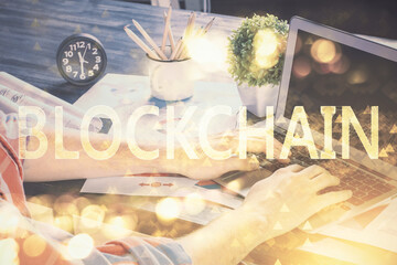 Crypto currency theme hologram with businessman working on computer on background. Concept of blockchain. Multi exposure.