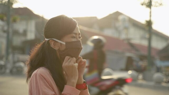 wearing face masks on new normal. covid 19 virus prevention woman asian sitting in the sidewalk