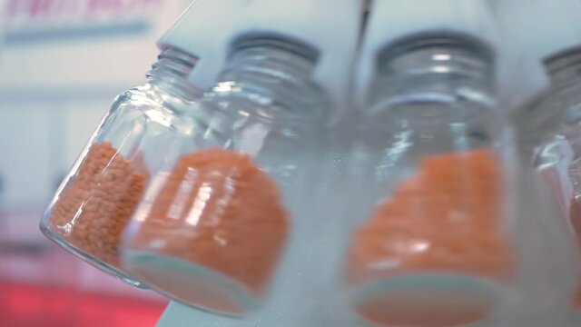 Super slow motion: rotary sample divider for analytical measurement of solid materials at pharmacy lab, medical exhibition: close up. Chemistry, science, pharmaceutical, laboratory equipment concept
