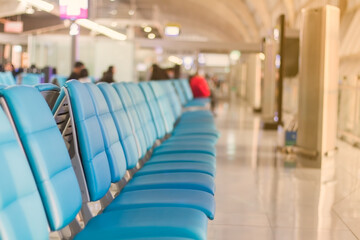 The chair is closed in the blue sky For waiting to sit inside the guest house before boarding in the airport and with warm orange light, the picture is partially clear