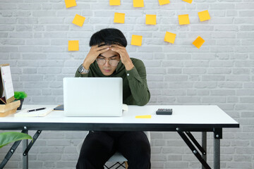 man freelancer feeling tired frustrated stressed from hard work. exhausted businessman have headache