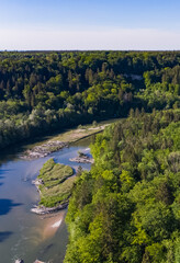 River flow through german forest seen from above bird view. Spring time for the Isar river flowing to Munich.
