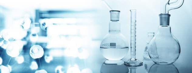 round glass flask with extraction set and blue chemical molecular structure and laboratory...