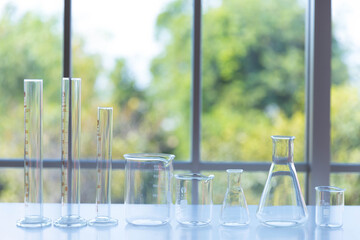 clear scientific glassware, the different size of laboratory glassware, beakers or flasks on white...