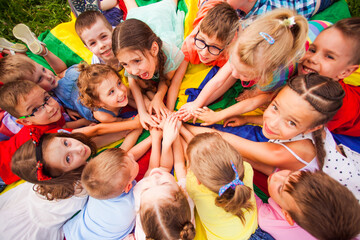 Top view kids in circle laying on colorful cloth - 356952734