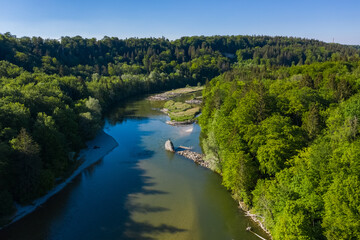 Fototapeta na wymiar Aerial drone view of Isar river flowing across bavarian forest seen from above in the south of Munich near Baierbrunn town.