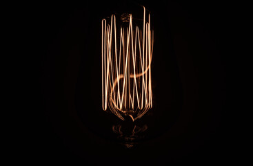 old fashioned light bulb on black