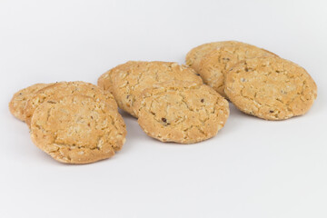 Closeup cereal cookies are arranged in multiple pieces and have three rows, and the cookies are brown and the image has a blank area next to the object and has a white background.