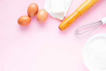 Frame of food ingredients on a pastel pink background. Baking concept. Top view.