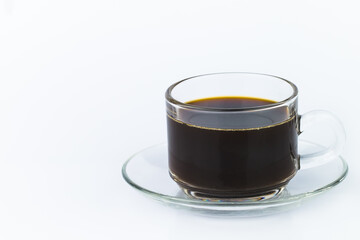 Closeup of black coffee in a clear glass container The image has blank space beside the object and has a white background. The image is partially clear.
