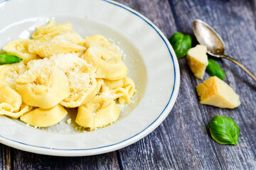 Home made vegetarian  italian  bio  egg  fresh   tortelloni pasta   for cheese garnished  with olive oil    and parmesan cheese