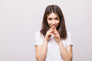 Young girl looks slyly, rubbing her hands isolated on white background