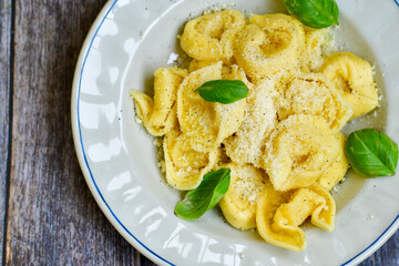 Home made vegetarian  italian  bio  egg  fresh   tortelloni pasta   for cheese garnished  with olive oil    and parmesan cheese