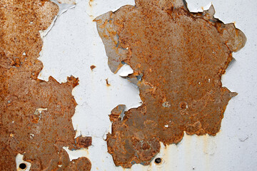 Rusty metal surface. Peeling paint. Steel with drilled holes