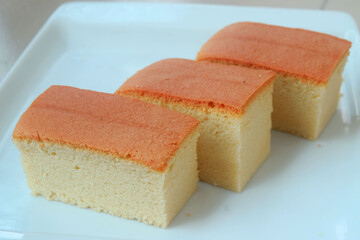 Closeup view 3 slice of Japanese Cotton sponge cake on white plate. Delicious cake ready to serve on a white plate.