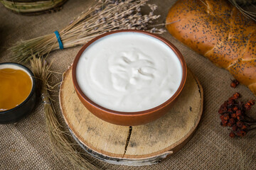 
Thick sour cream in a pot on the table