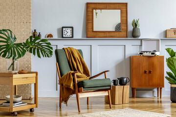  Elegant interior of home room with design armchair, retro furniture, wooden mirror, shelf,...