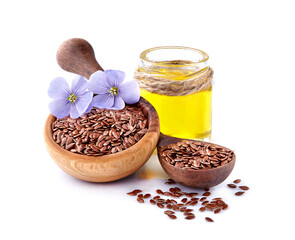 Flax seeds in wooden spoon with oil on white background.