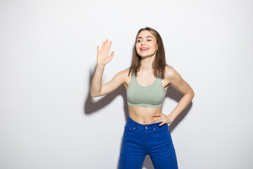 Fototapeta premium Young woman greeting with hands isolated on white background