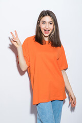 Cheerful smiling girl showing peace sign isolated on white background