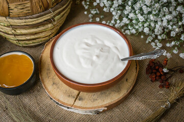 
Thick sour cream in a pot on the table