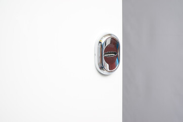 Glossy white interior entrance metal door with details: handle, open closed lock, hinges and...