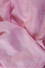 Obraz na płótnie Canvas top view closeup on crumpled soft pink colored textured silk female scarf