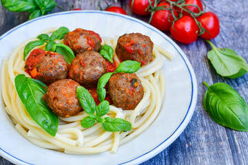 Spaghetti pasta Italian home made meal. Mediterranean food concept .Spaghetti pasta meatballs with tomato sauce, basil, herbs ,parmesan cheese 