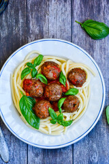 Spaghetti pasta Italian home made meal. Mediterranean food concept .Spaghetti pasta meatballs with tomato sauce, basil, herbs ,parmesan cheese 