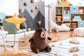 Modern scandinavian interior design of childroom with mint armchair, climbing wall for kids, design...