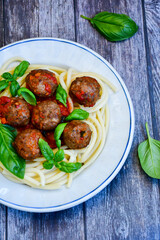 Spaghetti pasta Italian home made meal. Mediterranean food concept .Spaghetti pasta meatballs with tomato sauce, basil, herbs ,parmesan cheese 