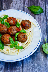 Spaghetti pasta Italian home made meal. Mediterranean food concept .Spaghetti pasta meatballs with tomato sauce, basil, herbs ,parmesan cheese 