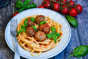 Spaghetti pasta Italian home made meal. Mediterranean food concept .Spaghetti pasta meatballs with tomato sauce, basil, herbs ,parmesan cheese 