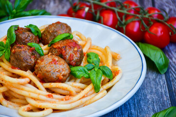 Spaghetti pasta Italian home made meal. Mediterranean food concept .Spaghetti pasta meatballs with tomato sauce, basil, herbs ,parmesan cheese 