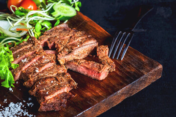 Grilled beef steaks and healthy salads on the table